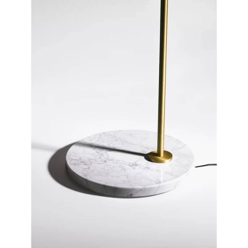 The Captain Flint Floor Lamp by Flos in brass highlighting the marble base.