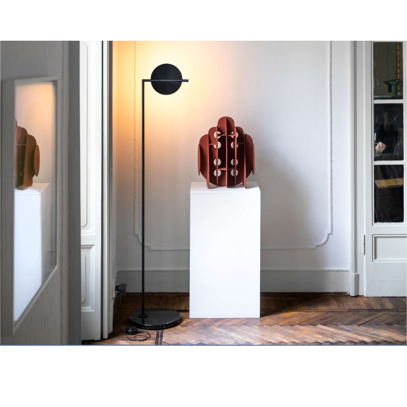 The Captain Flint Floor Lamp by Flos adjusted to illuminate a wall with indirect light.