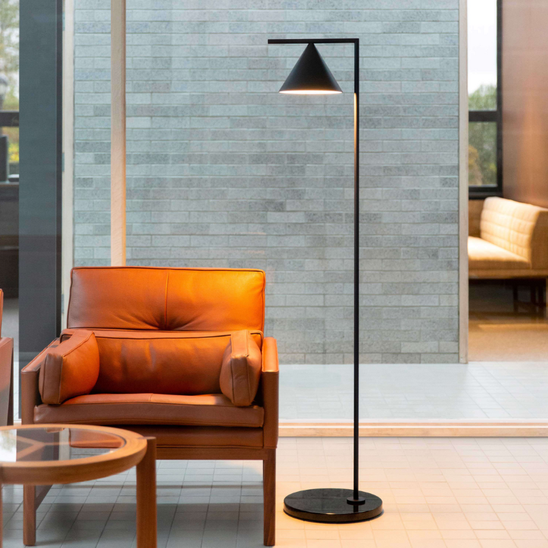 The Captain Flint Floor Lamp by Flos used as a reading lamp in an office.