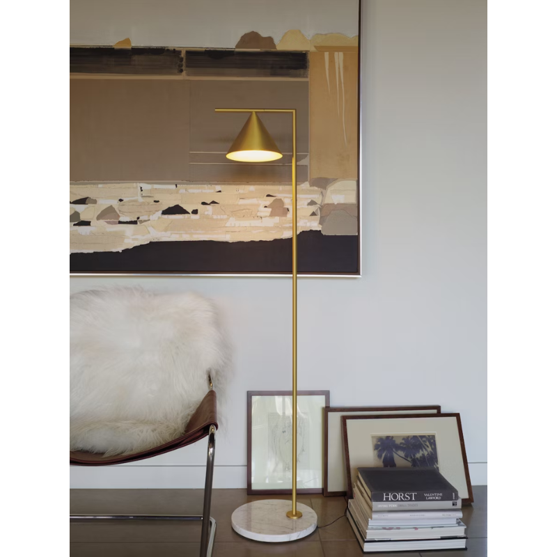 The Captain Flint Floor Lamp by Flos in brass with marble base in a living room.