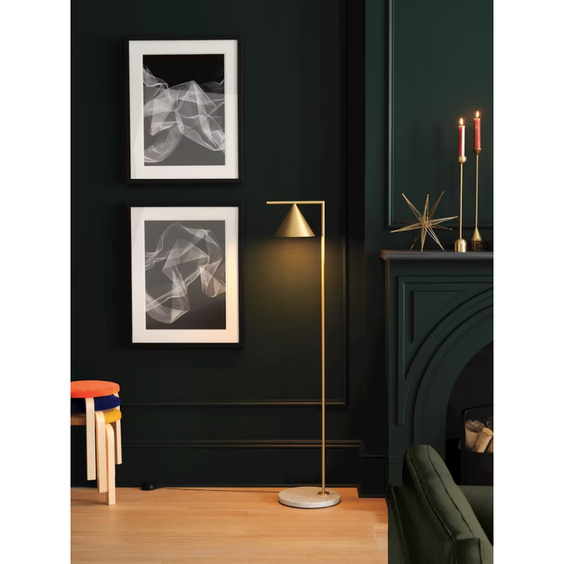 The Captain Flint Floor Lamp by Flos in brass with marble base in an office.