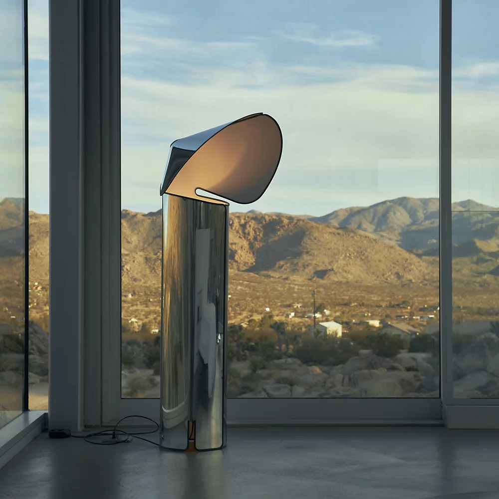 The Chiara Floor Lamp by Flos in a window.