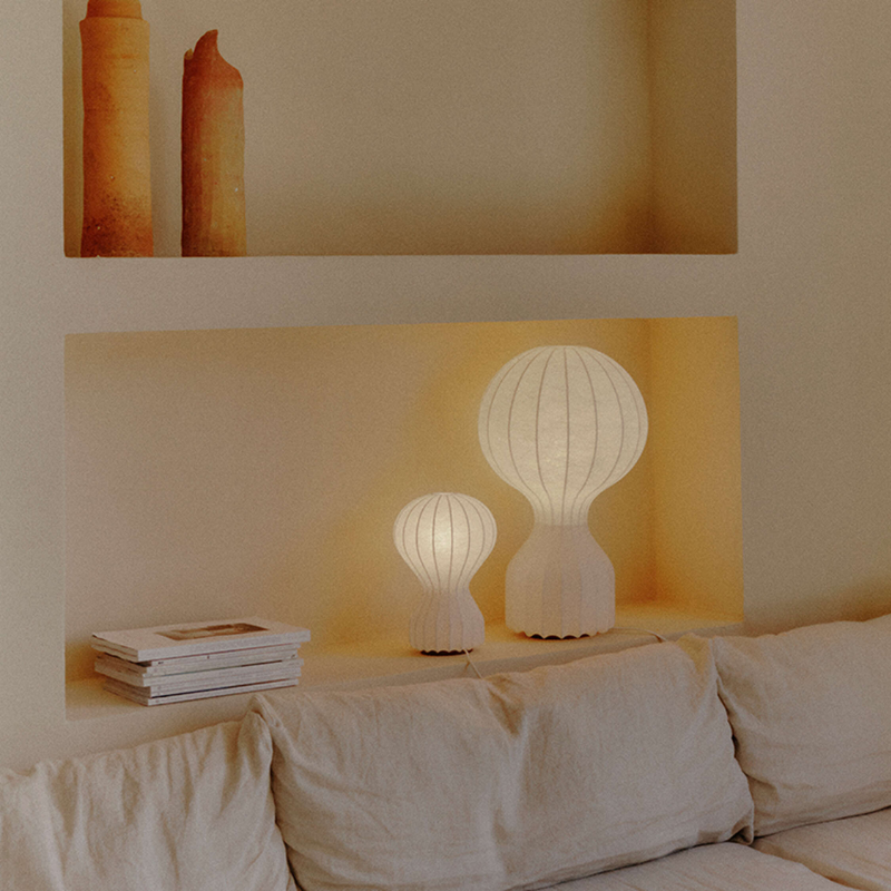 The small and large Gatto Table Lamp from FLOS in a family area. all-groups