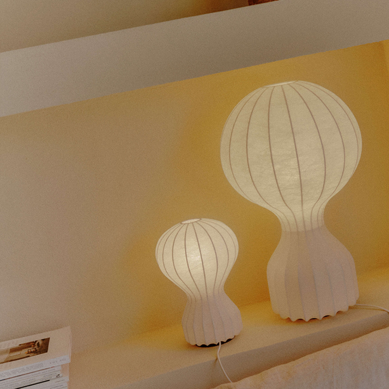 The small and large Gatto Table Lamp from FLOS in a living space. all-groups