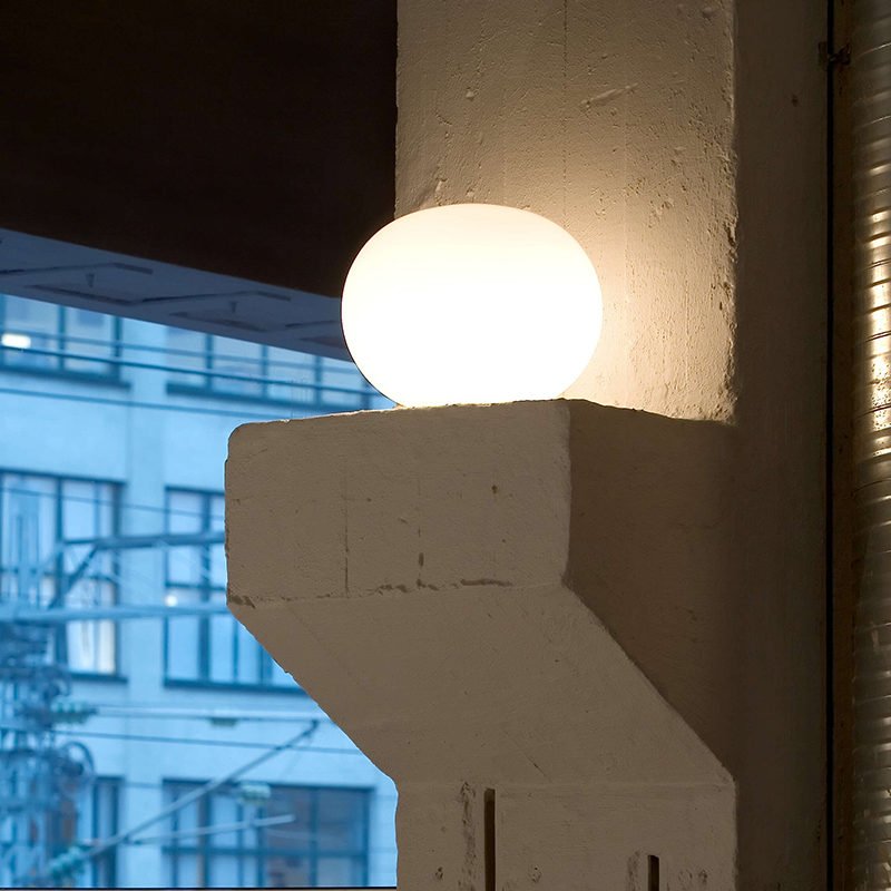 The 13 inch Glo-Ball Basic Table Lamp from Flos in a living space.