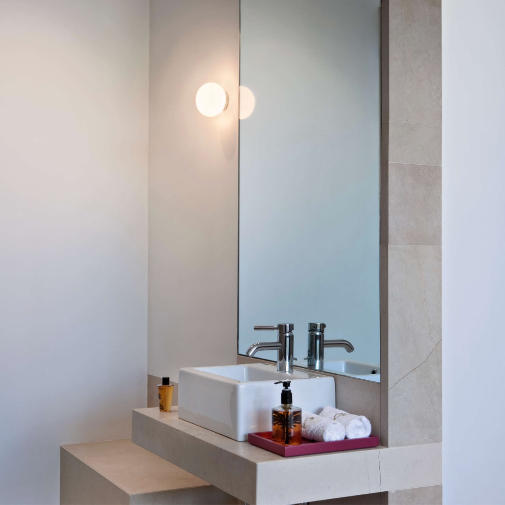 The Glo-Ball Mini Ceiling/Wall Light from Flos in a bathroom.