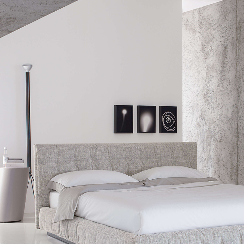 The Luminator Floor Lamp from FLOS in anthracite in a primary bedroom.