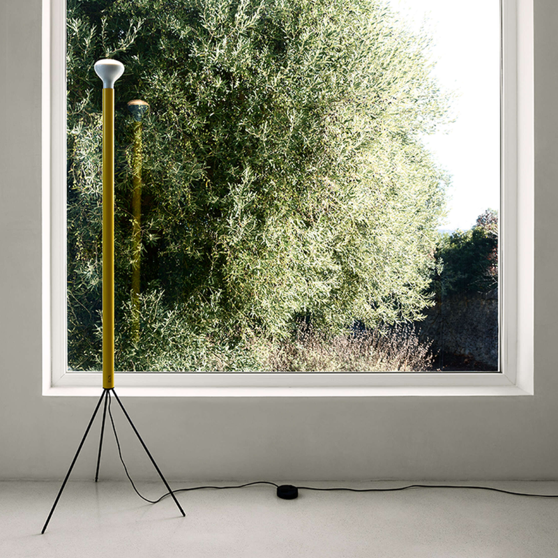The Luminator Floor Lamp from FLOS in yellow in a guest room.
