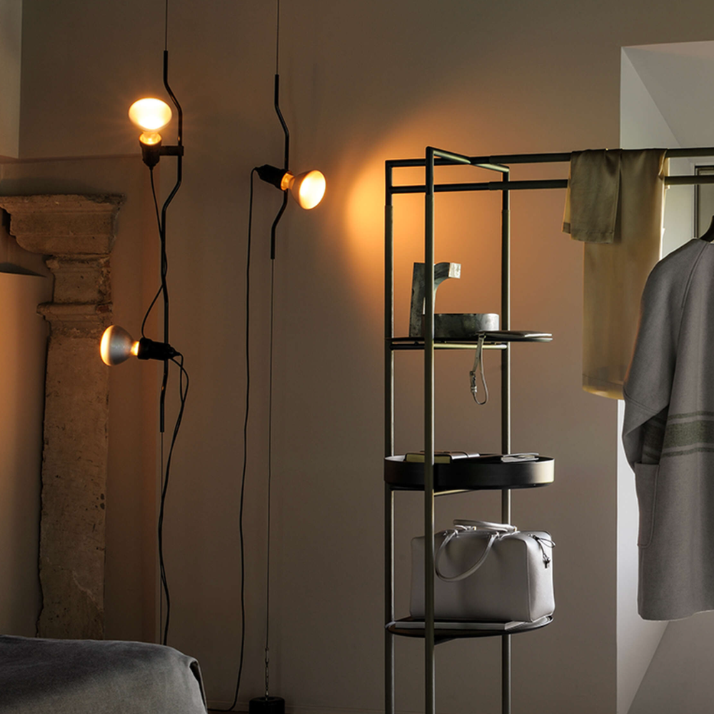The Parentesi Lamp from Flos in Black in a closet.