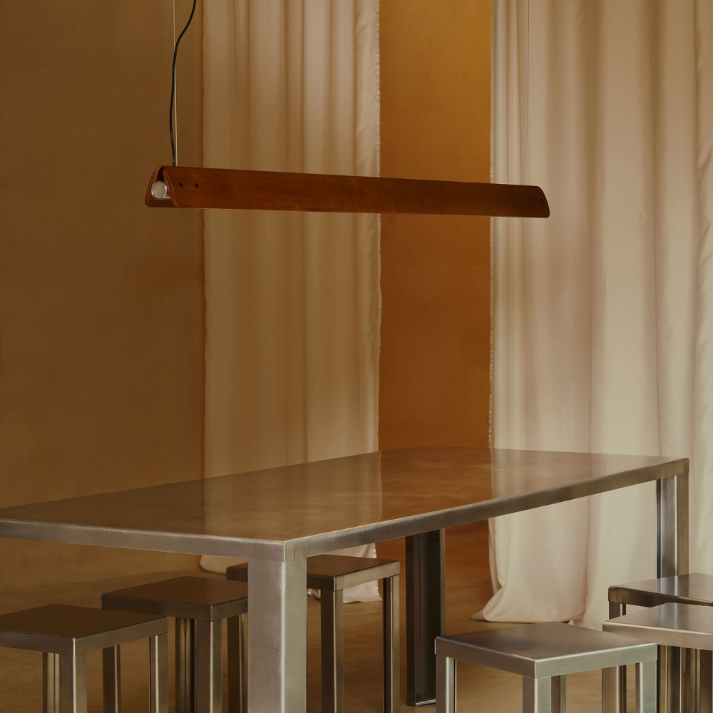 The Seki-Han Linear Pendant by FLOS over a dining table.