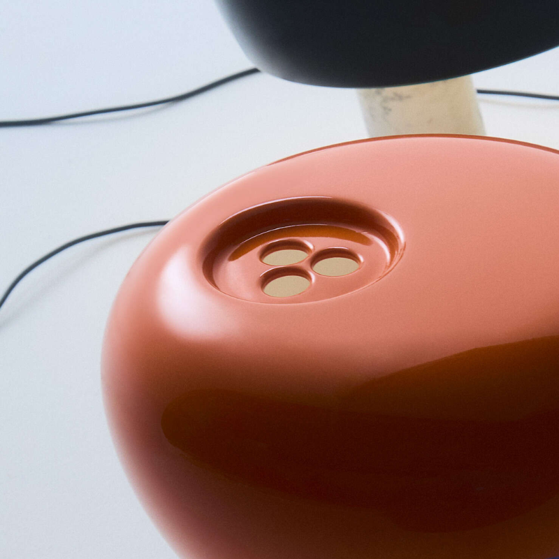 The Snoopy Table Lamp from FLOS in orange close up.