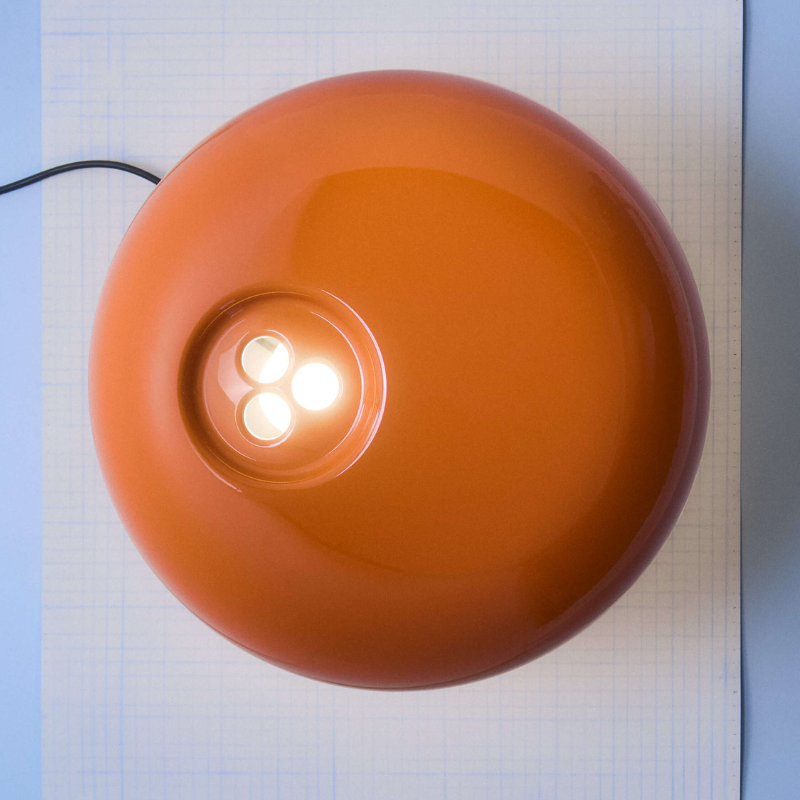 The Snoopy Table Lamp from FLOS in orange in detail.