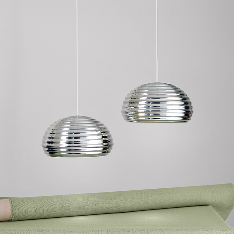 The Splugen Brau Suspension from Flos in a dining room.