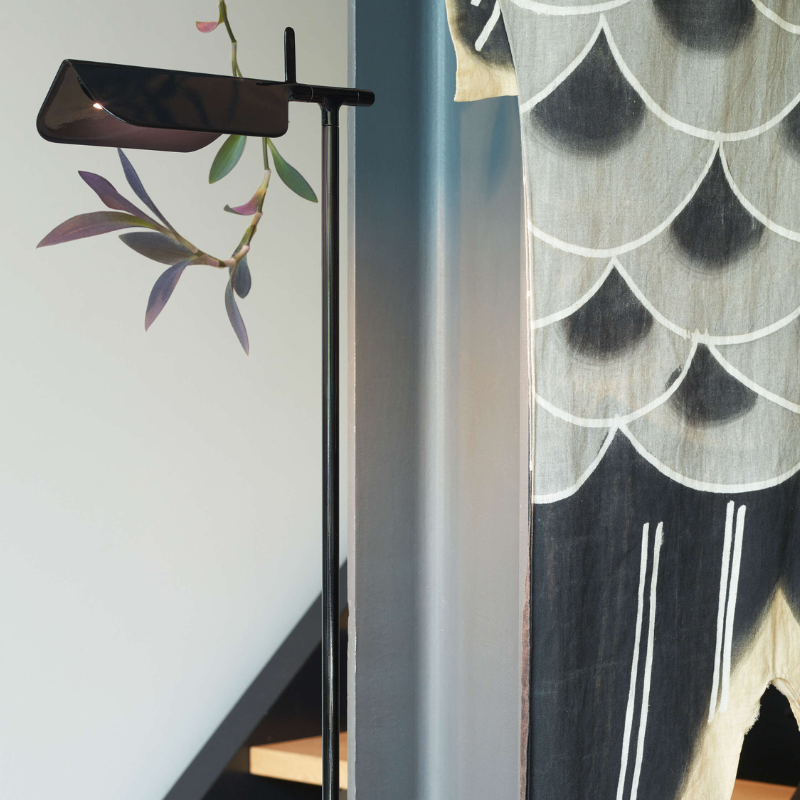 The Tab Floor Lamp from FLOS in black in a living space.