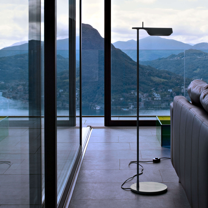 The Tab Floor Lamp from FLOS in dark green in a study.
