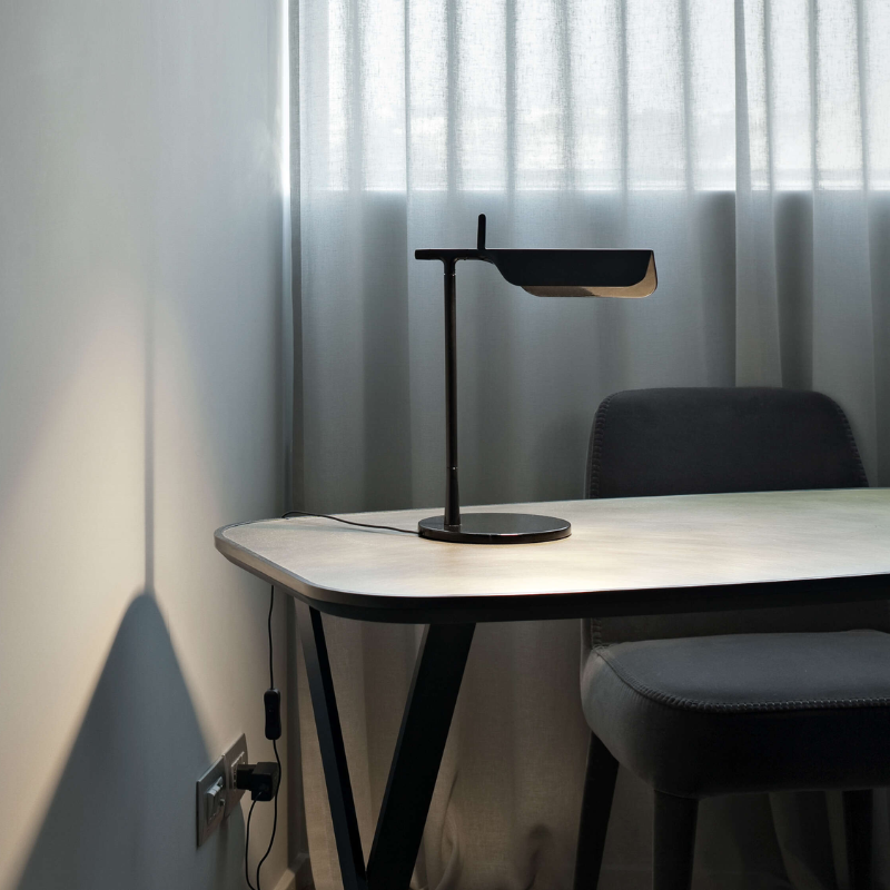 The Tab Table Lamp from FLOS in black in a home office.