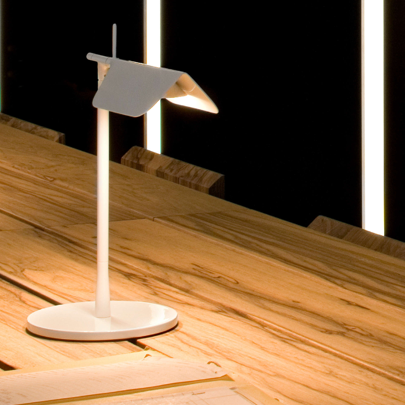 The Tab Table Lamp from FLOS in white in a lounge.