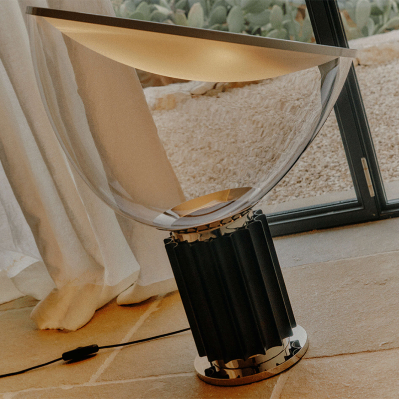 The standard Taccia Table Lamp from FLOS in black in a family space.