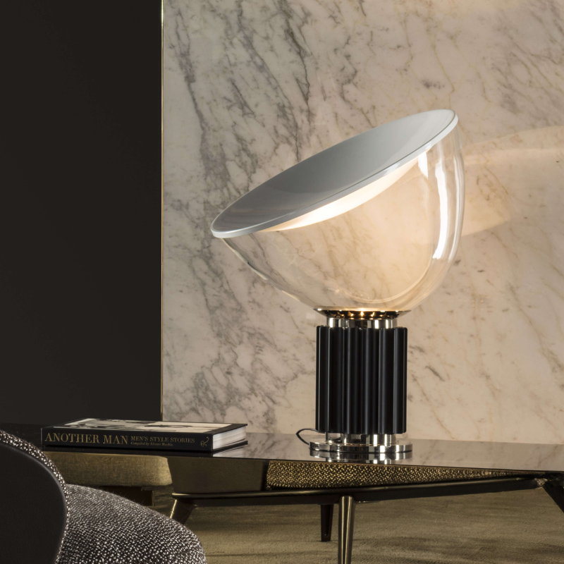 The standard Taccia Table Lamp from FLOS in black in a living room.
