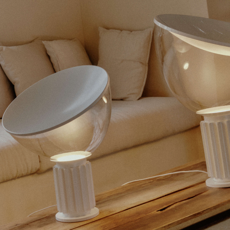 The standard Taccia Table Lamp from FLOS in matte white in a den.
