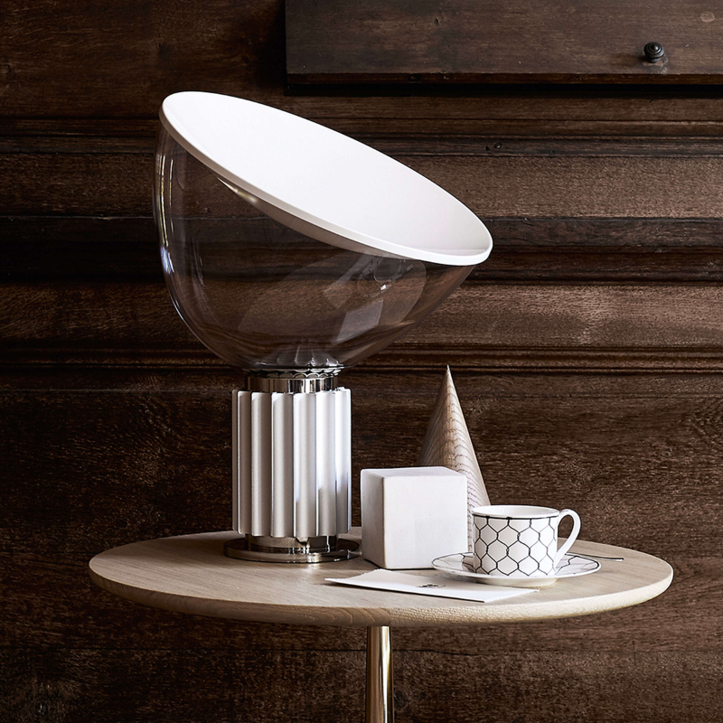 The small Taccia Table Lamp from FLOS in silver in a dining room.