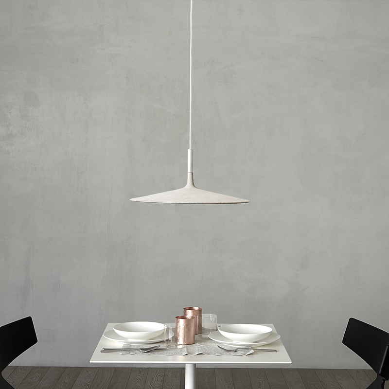 The Aplomb Large Pendant from Foscarini in white in a dining space.