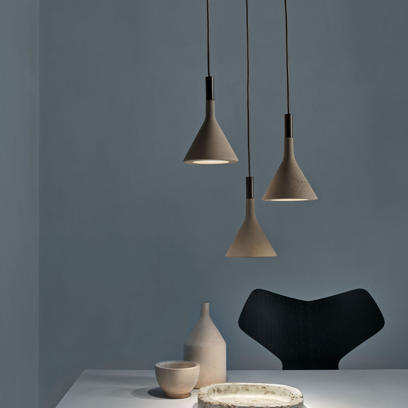 The Aplomb Pendant from Foscarini in brown in a dining room.