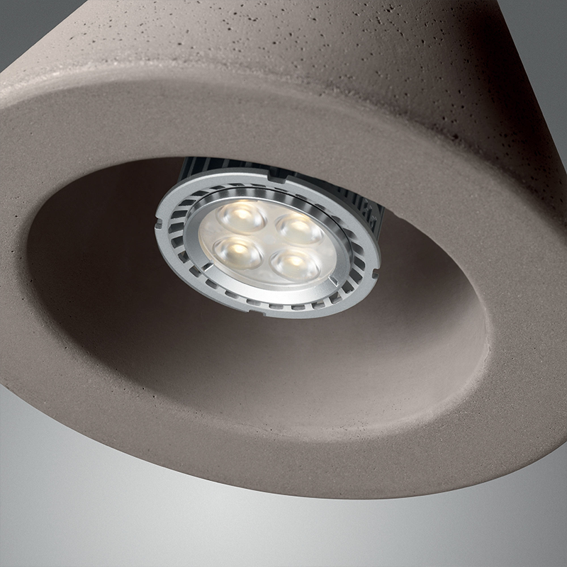 The Aplomb Pendant from Foscarini in concrete grey focusing on the bulb.