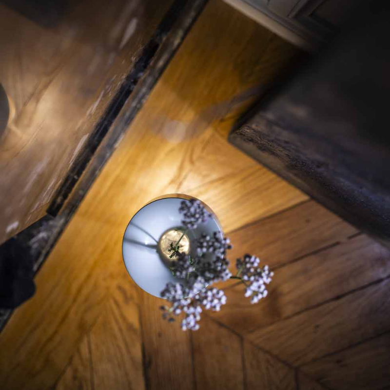 The Fleur Portable Lamp from Foscarini in white in a family area.