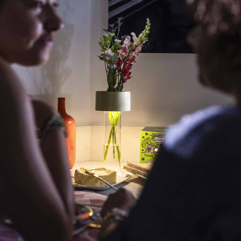 The Fleur Portable Lamp from Foscarini in white in a living room.