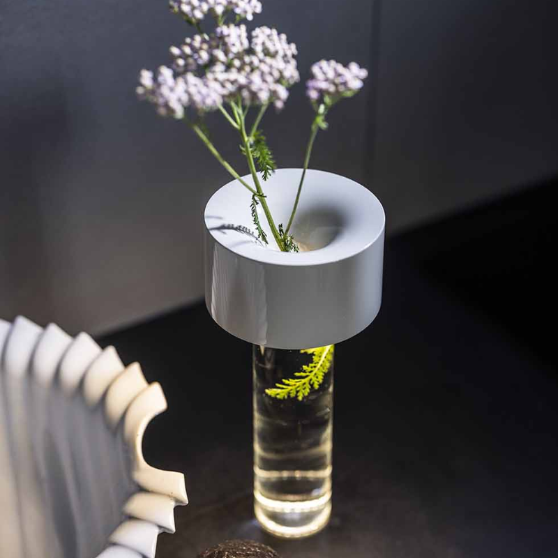 The Fleur Portable Lamp from Foscarini in white in a living space.