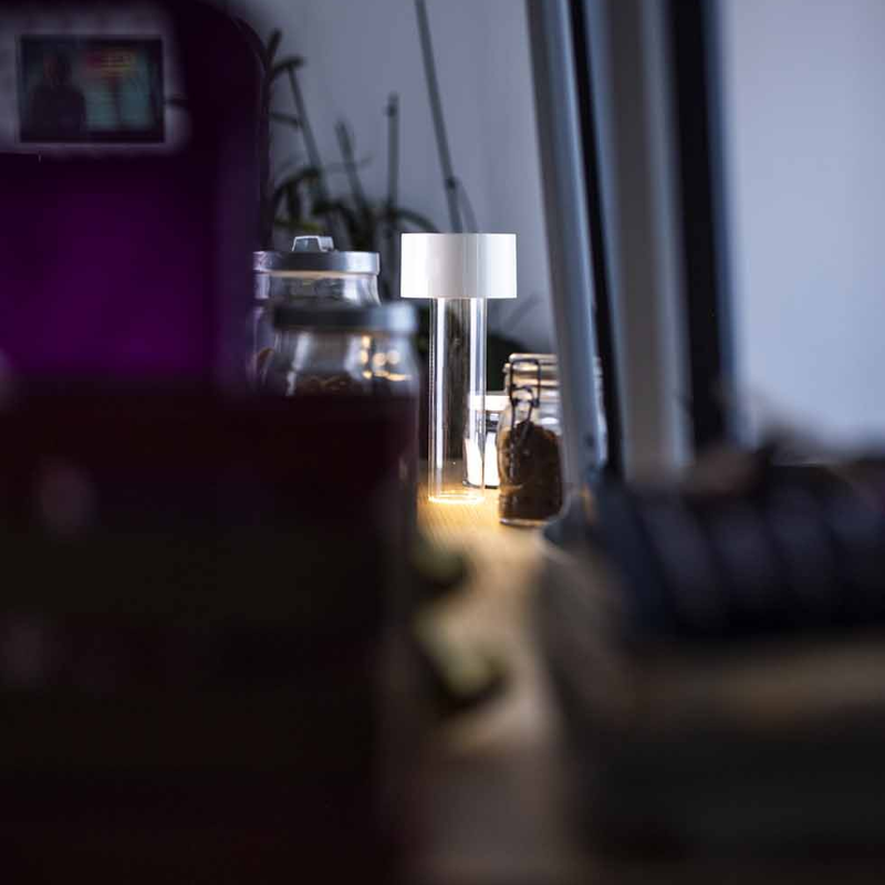 The Fleur Portable Lamp from Foscarini in white in a lounge.