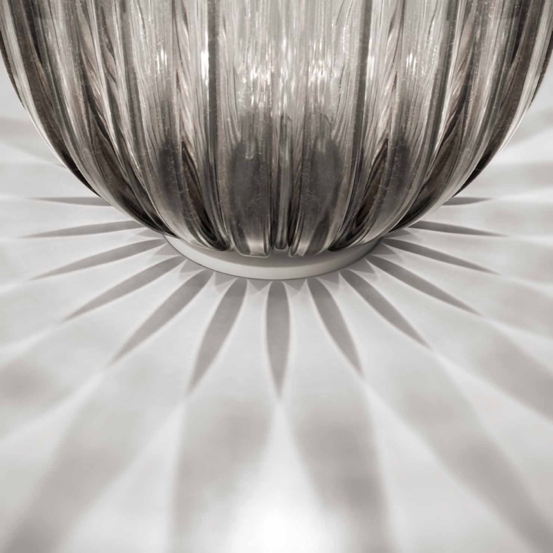 The Plass Table Lamp from Foscarini in grey in a close up.