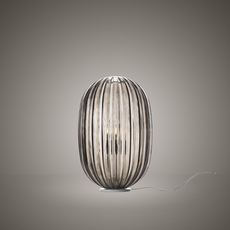 The Plass Table Lamp from Foscarini in grey in a studio.