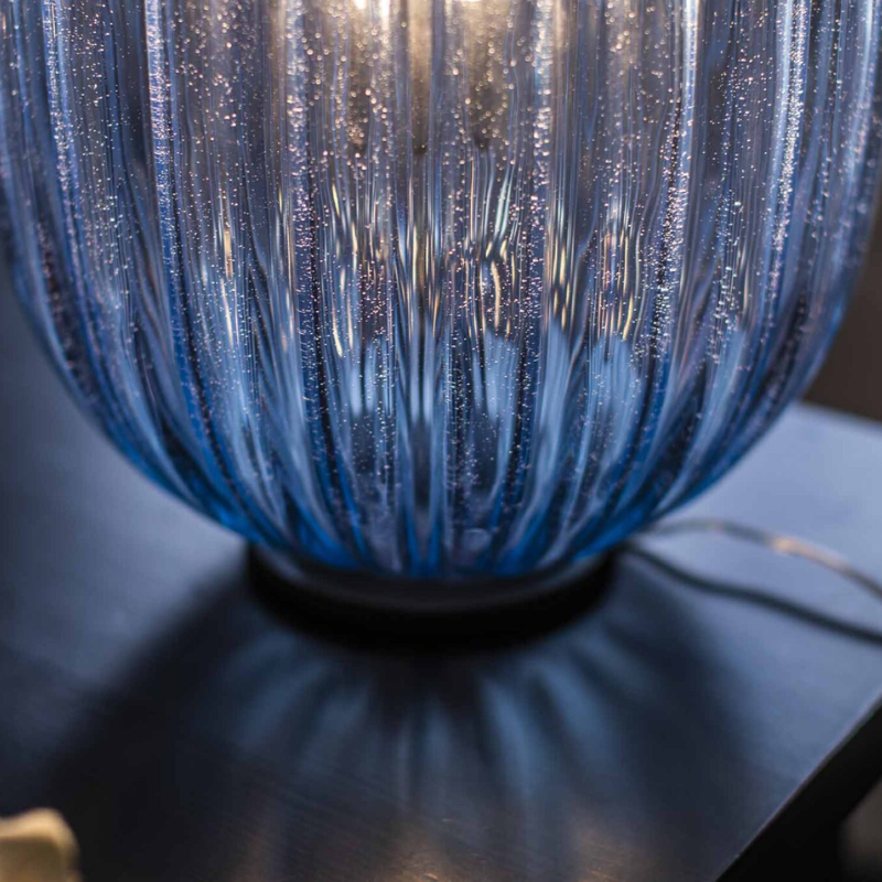 The Plass Table Lamp from Foscarini in light blue in detail.