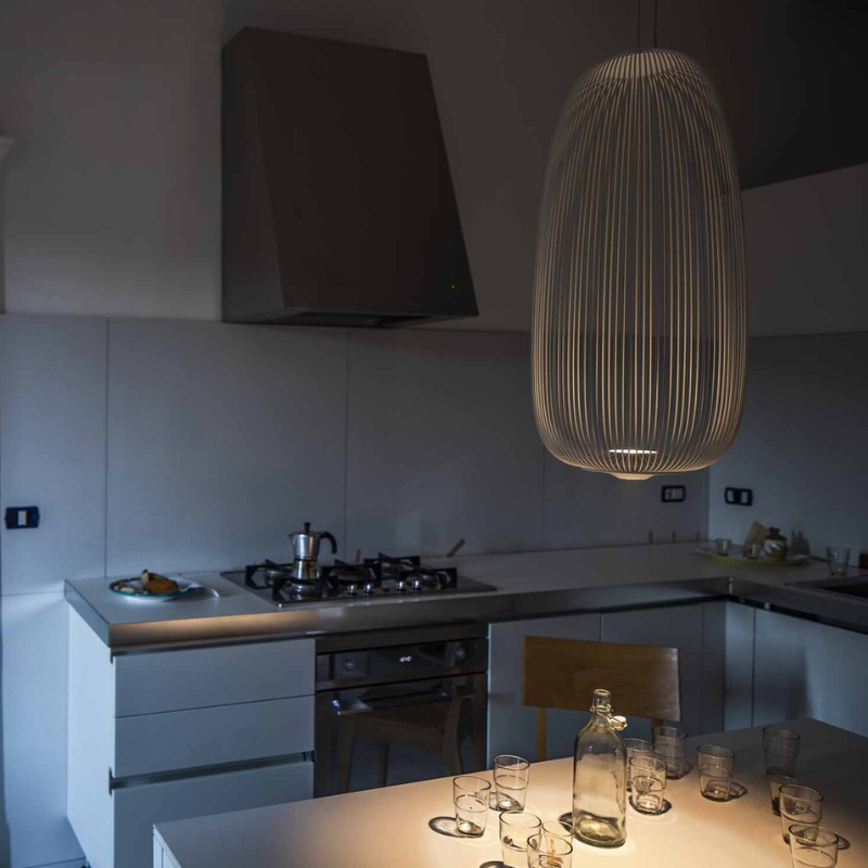 The Spokes 1 from Foscarini in copper in a klitchen and dining setting.