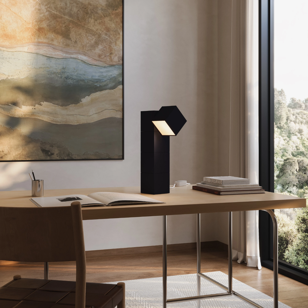 The carbon Analog Task Light from Gantri in a home office on top of a desk.