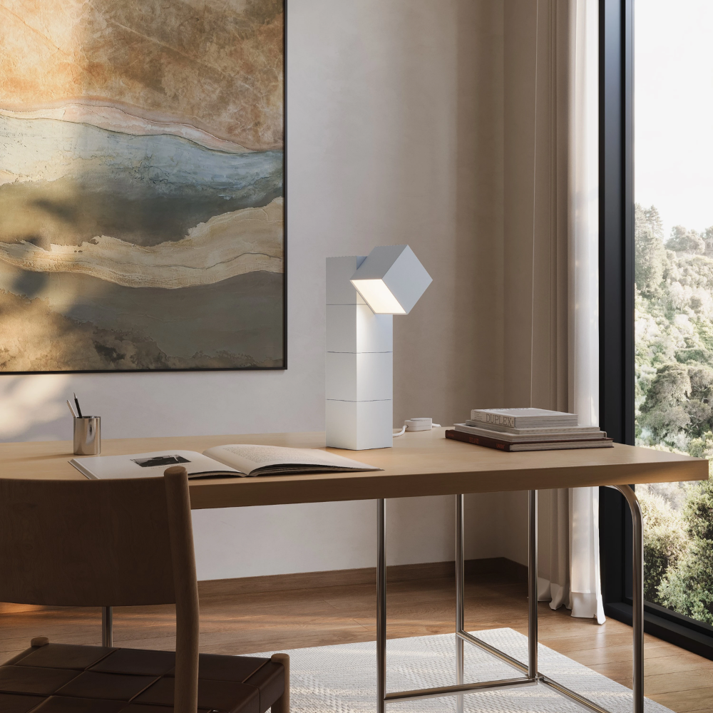 The snow Analog Task Light from Gantri in a home office on top of a desk.