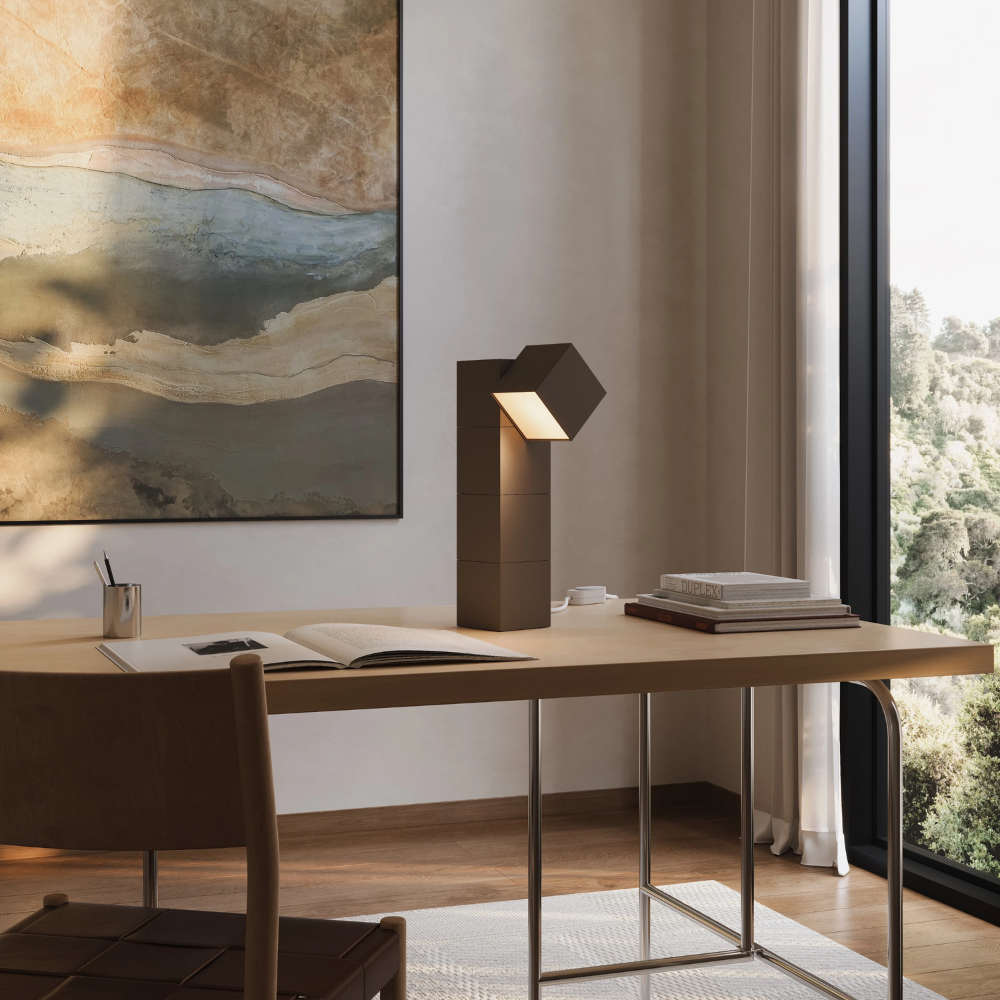 The walnut Analog Task Light from Gantri in a home office on top of a desk.