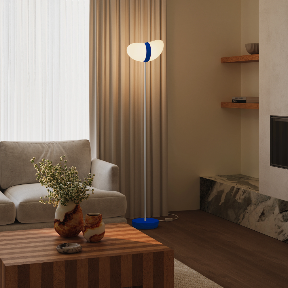 The cobalt Baltra Floor Light from Gantri with the white rod option in a lounge.