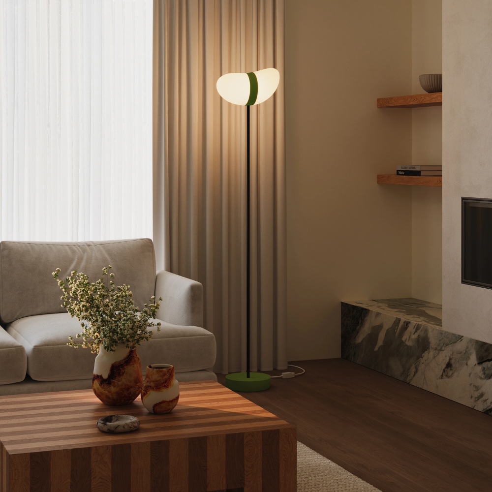 The olive Baltra Floor Light from Gantri with the black rod option in a living room.
