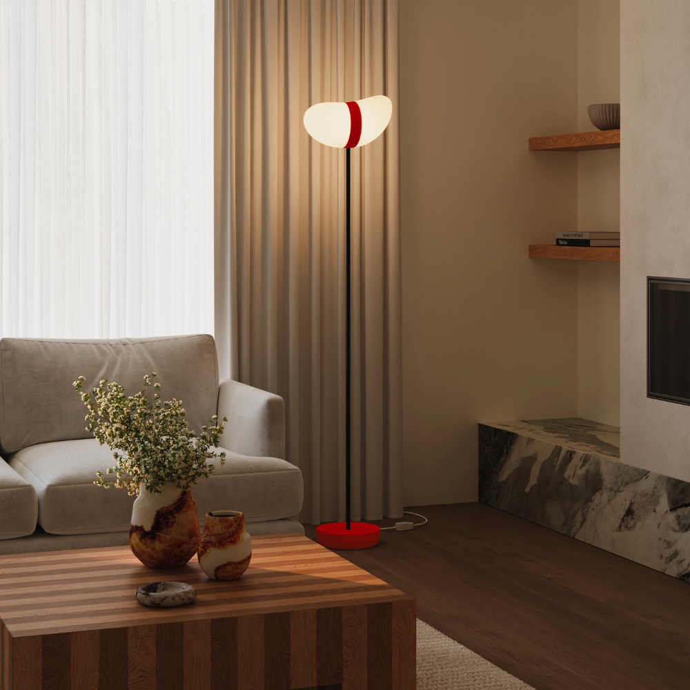 The poppy Baltra Floor Light from Gantri with the black rod option in a living room.