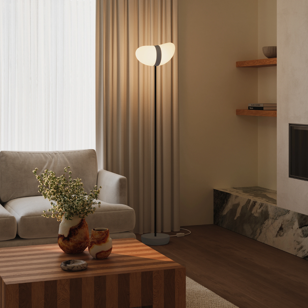 The smoke Baltra Floor Light from Gantri with the black rod option in a family space.