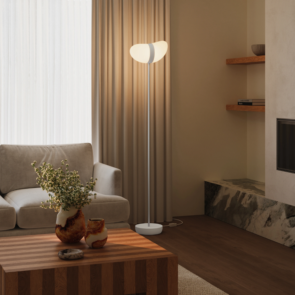 The snow Baltra Floor Light from Gantri with the white rod option in a lounge.