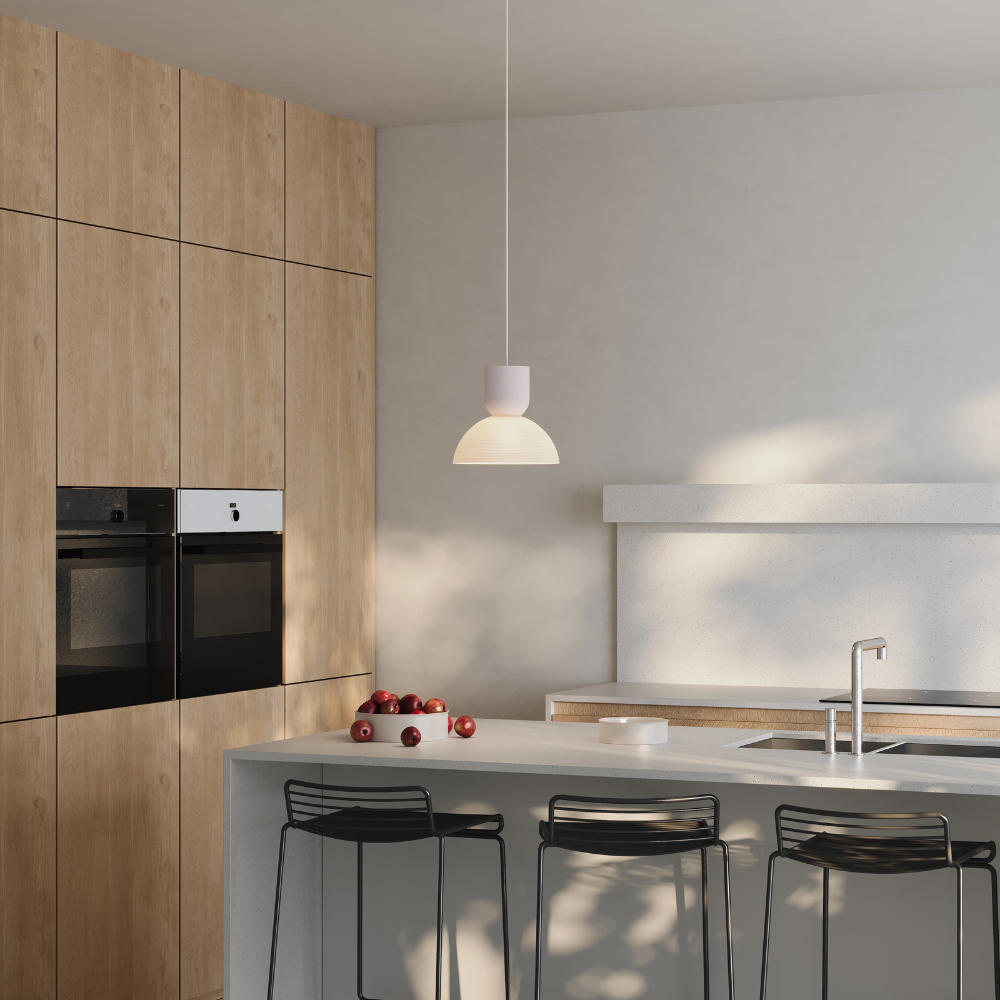The coral Buia Pendant Light from Gantri with the white cord in a family space.