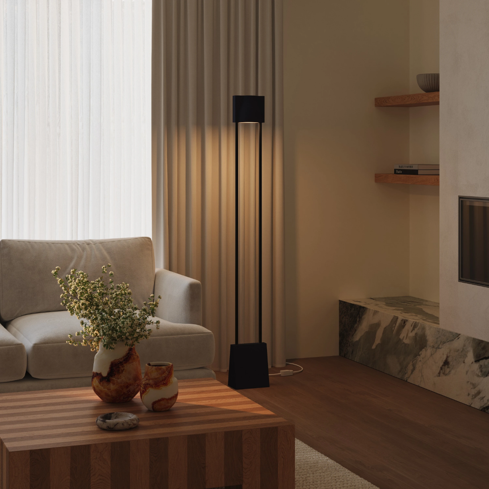 The carbon Carve Floor Light from Gantri with the black rod option in a living room.