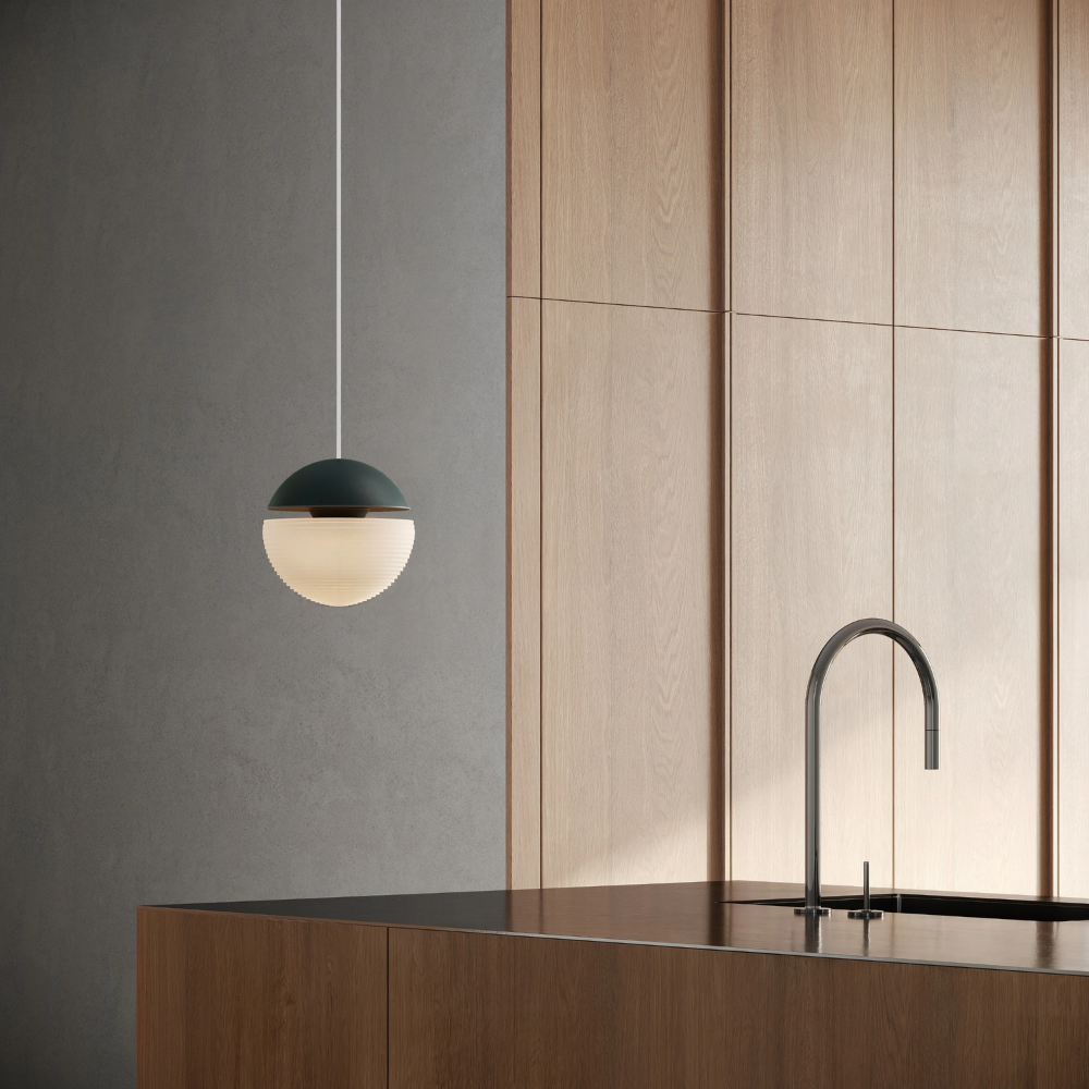 The forest Cora Pendant Light from Gantri with the white cord in a living room.