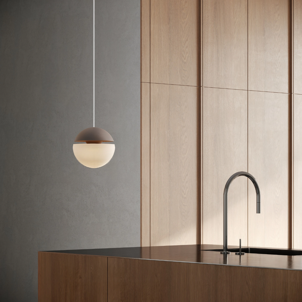 The smoke Cora Pendant Light from Gantri with the white cord in a living room.