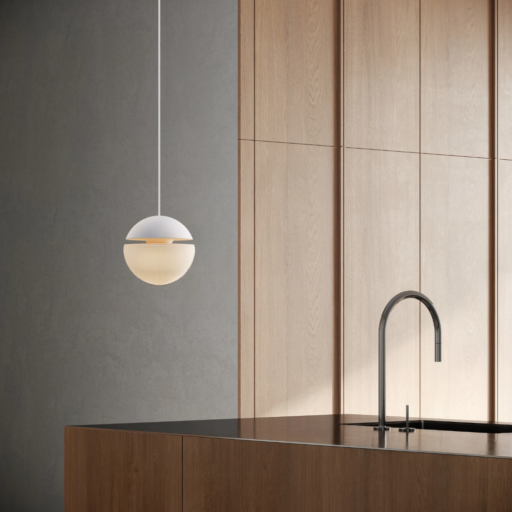 The snow Cora Pendant Light from Gantri with the white cord in a living room.
