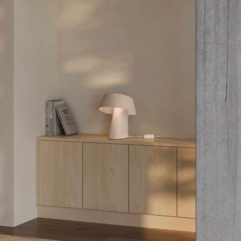 The peach Fold Table Light from Gantri in a living room.